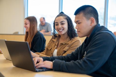 two students at a laptop computer