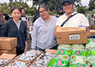 Three students at the food distribution