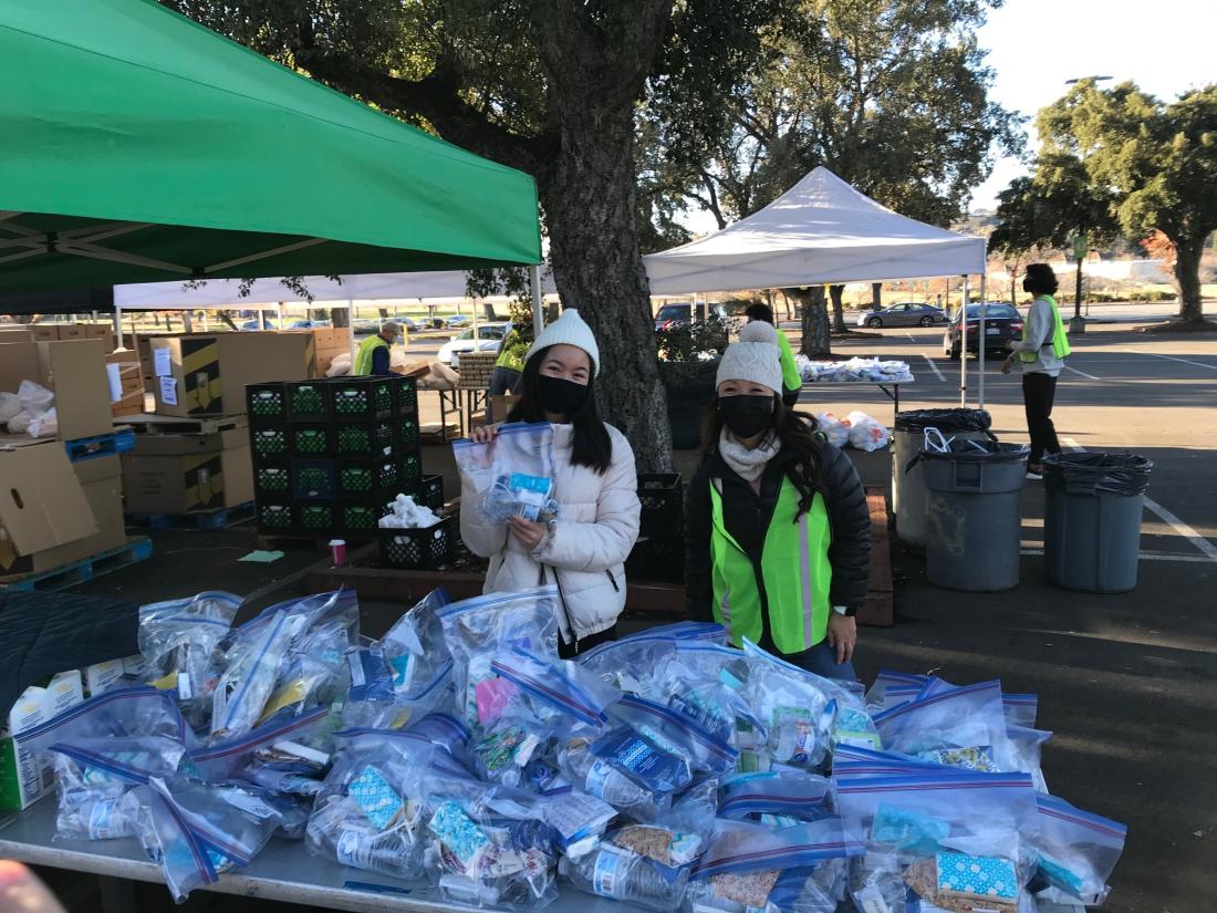 Volunteers handing out Basic Needs Package