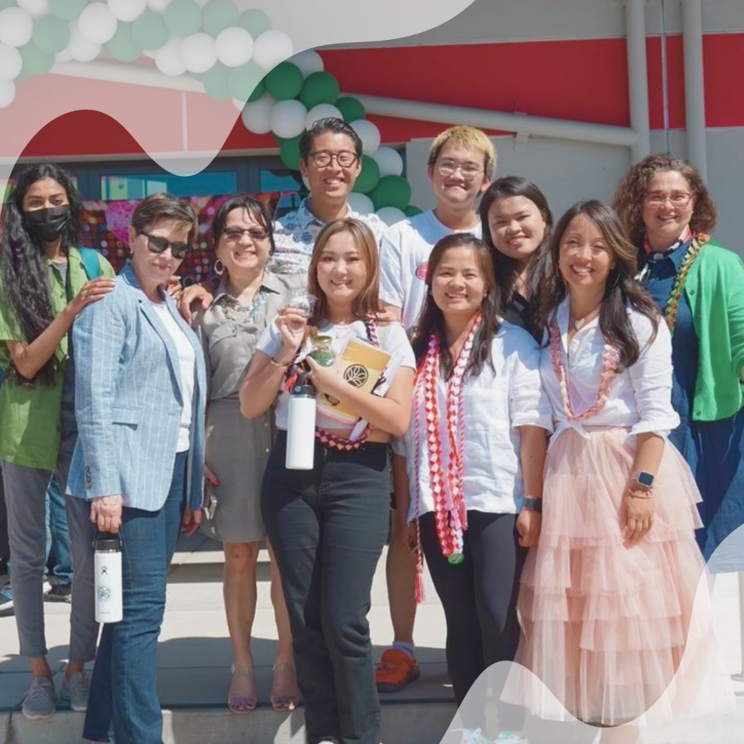 Group of students and school staff in front of a building