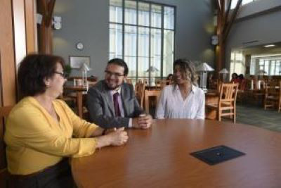 Three people sitting at a table