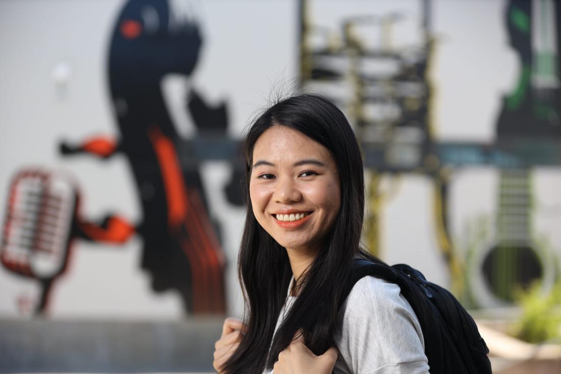 student smiling outside
