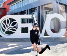 Student standing in front of the college