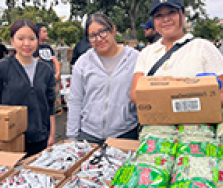 Three students at the food distribution