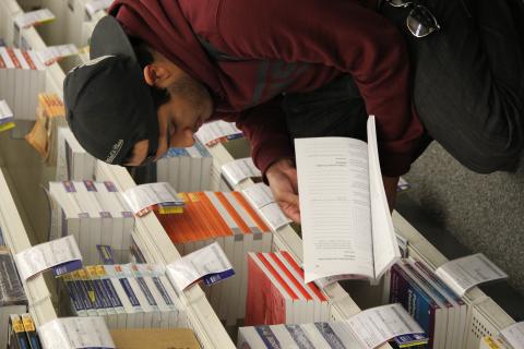 Student checking out textbooks at the Bookstore