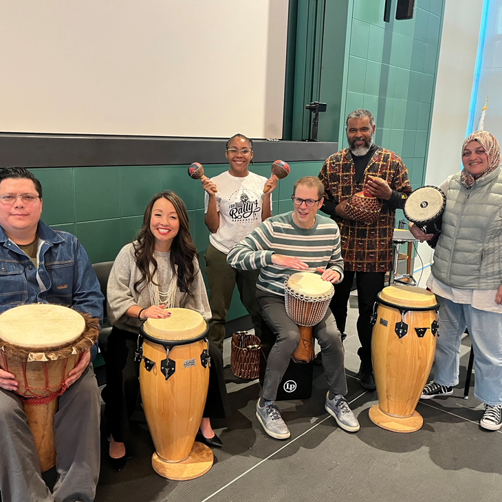 President Gilkerson learning the Conga drums as part of the “Teach Tammeil Tuesday” series 