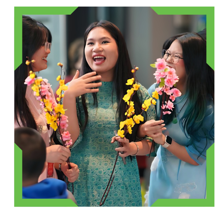 Group of students wearing traditioanal Vietnamese dresses.
